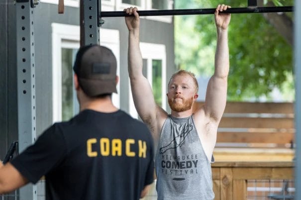 Man working out fith a coach